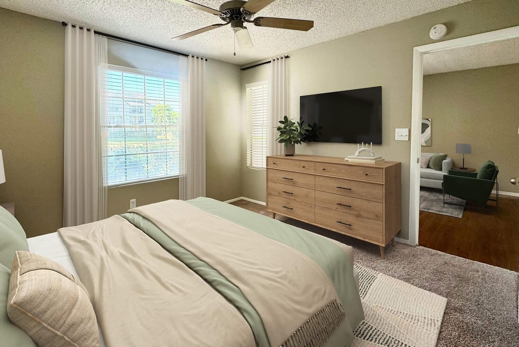 bedroom with carpet flooring, windows, and mounted television.