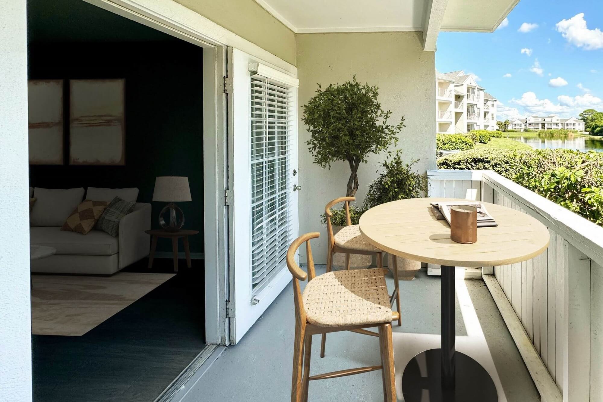 balcony with table seating, plant decor, and view of surrounding lake.