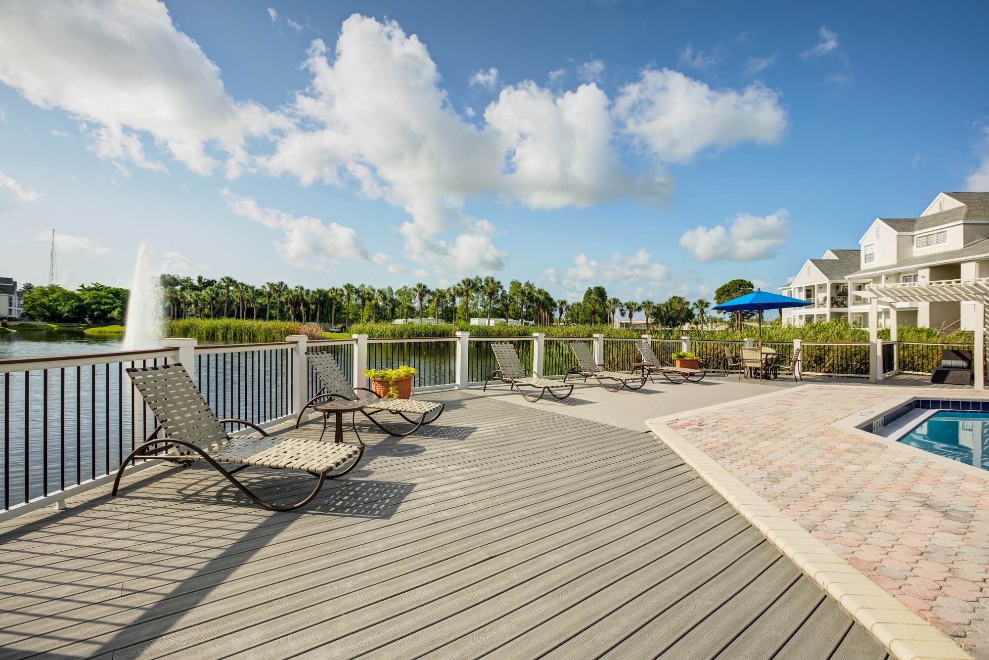 pool deck with lounge chairs and view of fountain.