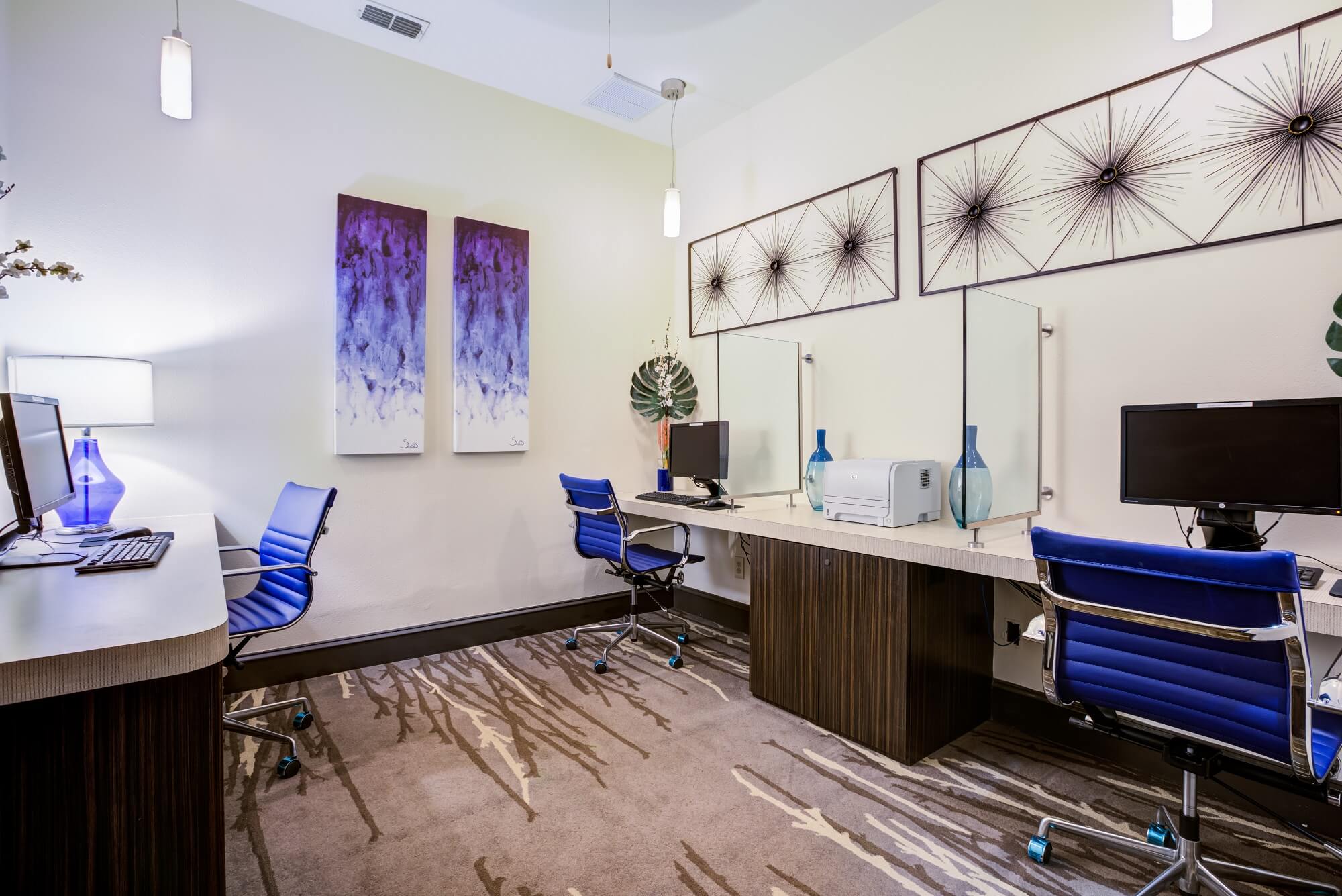 business center with computers and blue accent decor.