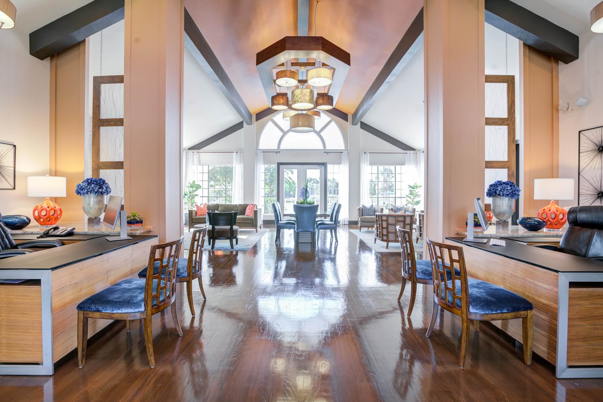 clubhouse view with high ceilings and blue accent seating.