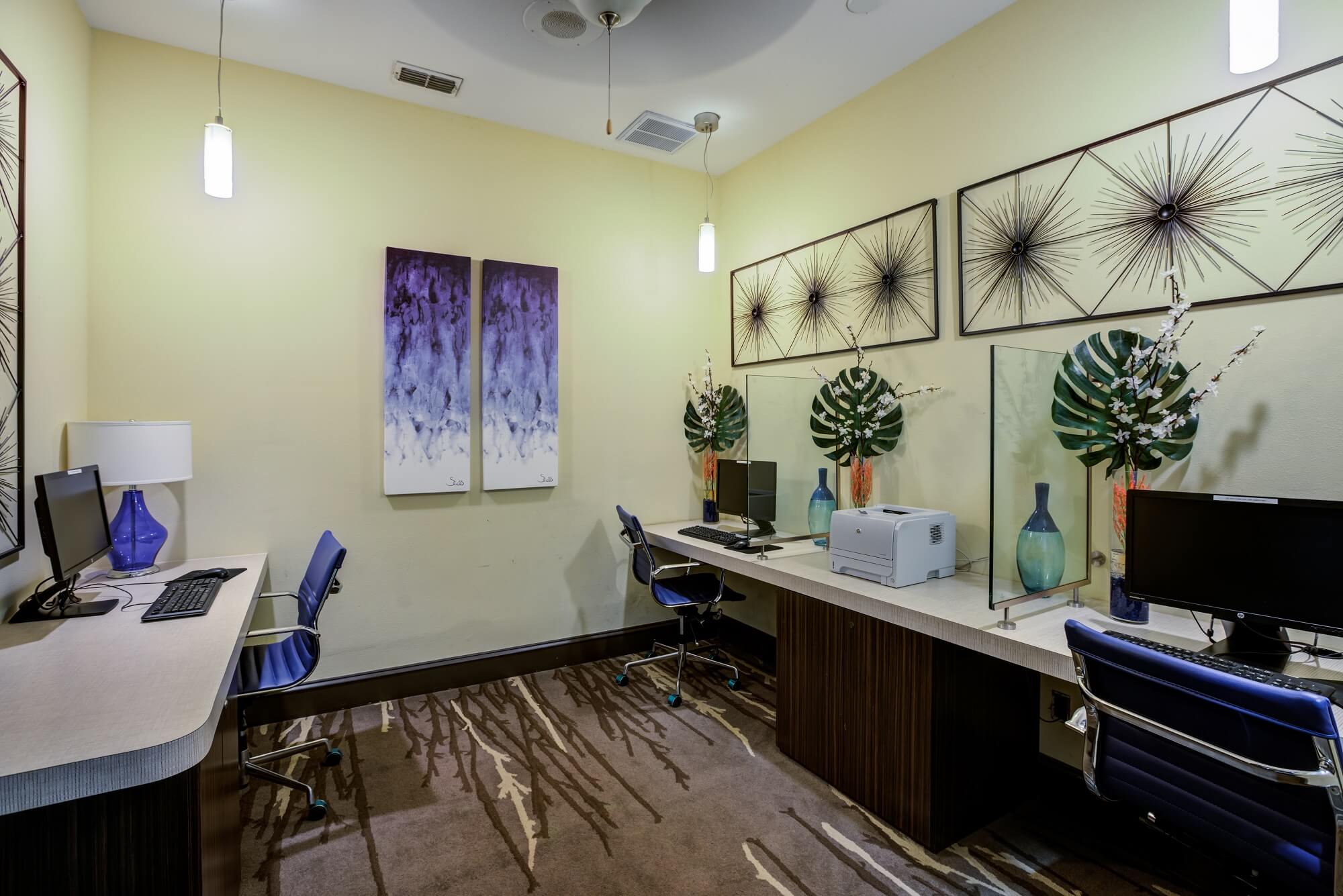 business center with computers and blue accent decor.