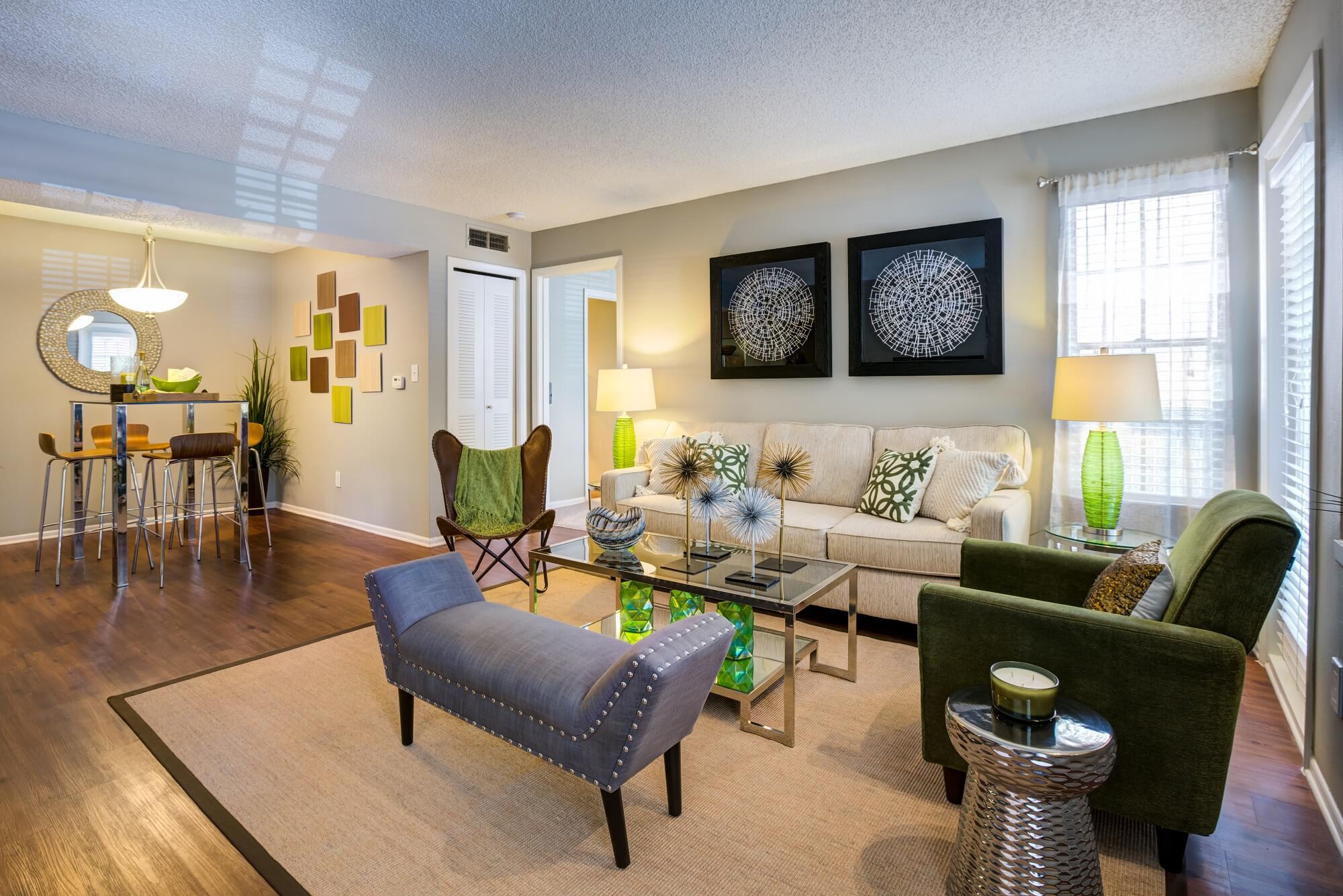 living and dining area with wood floors, decor, and view of bedroom.